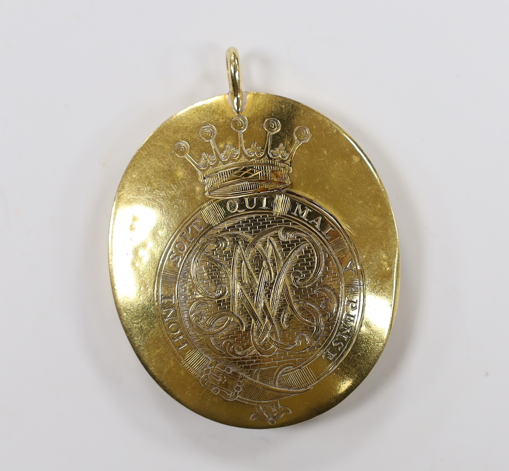 A 19th century yellow metal mounted oval pendant with inset watercolour on ivory miniature portrait bust of a gentleman, verso with engraved monogram with motto and coronet, overall, 55mm, gross weight 24.9 grams (a.f.).